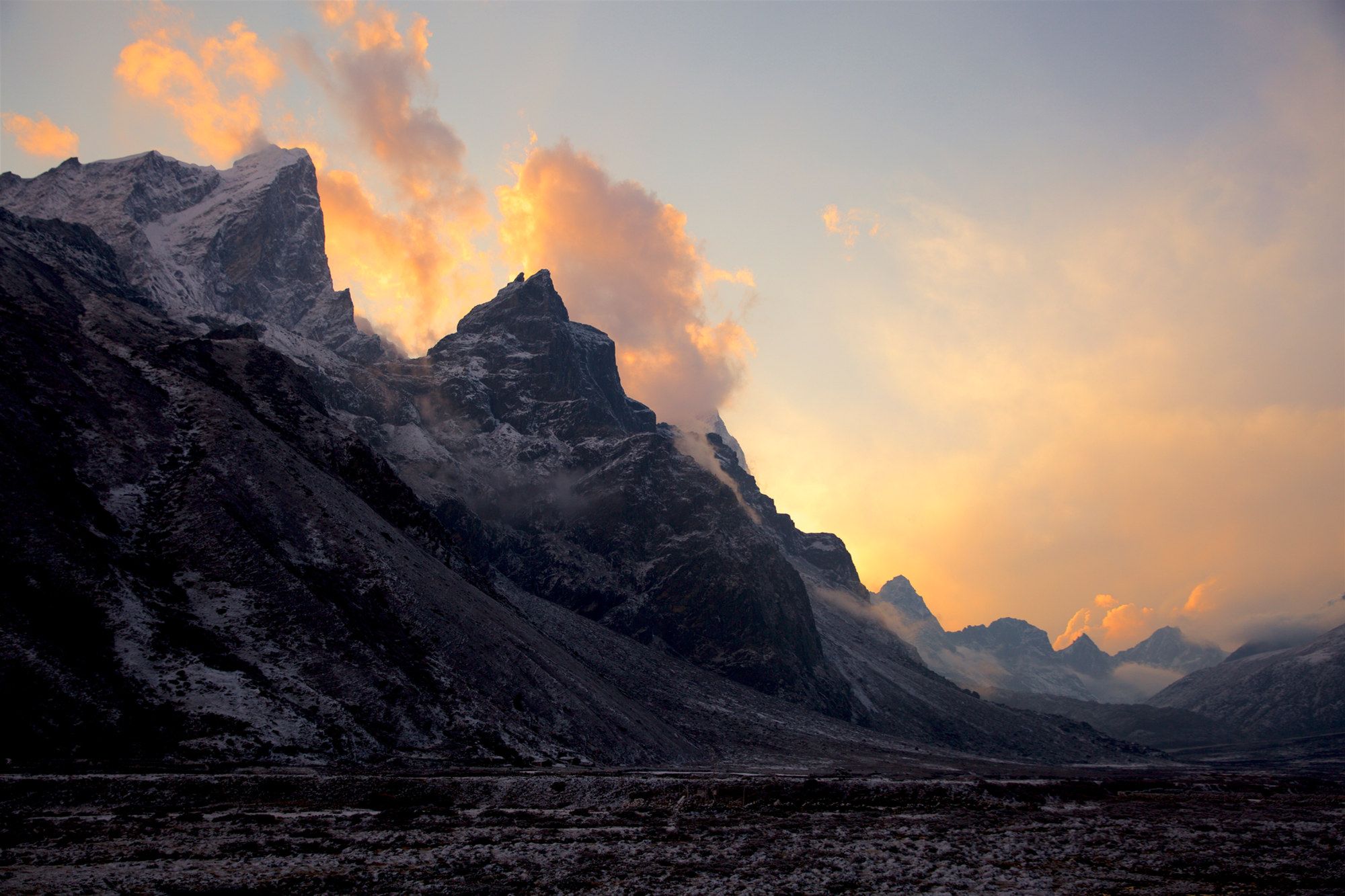 Alpenglow turning a snow-covered Himalayan summit pink at sunset